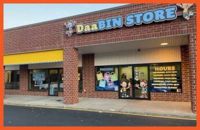 Exterior of DaaBIN Store – Newport News, VA, featuring bright signage, colorful pricing posters on the windows, and a clean storefront in a red-brick plaza.